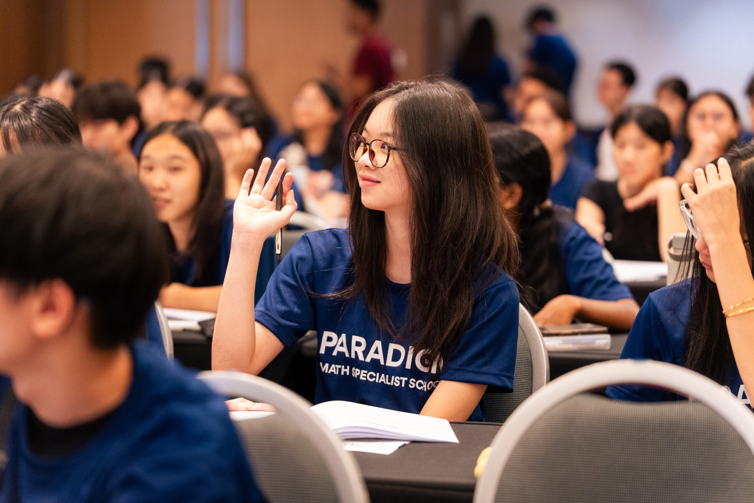 Paradigm students raising hands during the exam workshop